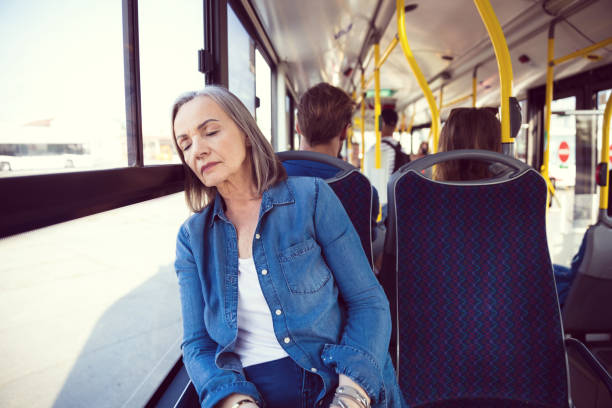 istock Senior woman sleeping while traveling in bus 1190134538