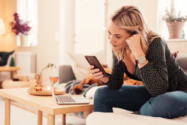 istock Woman with smartphone at home in sofa 1190135747