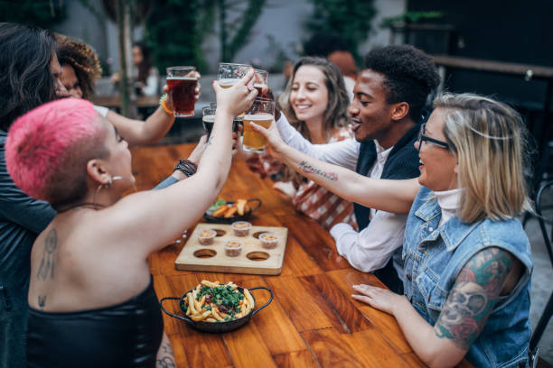 istock Friends drinking beer outdoors in pub 1190135920