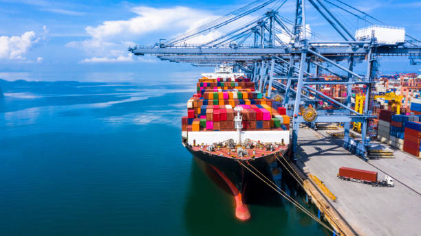 istock Container cargo ship at industrial port in import export business logistic and transportation of international by container cargo ship in the open sea. 1190136517