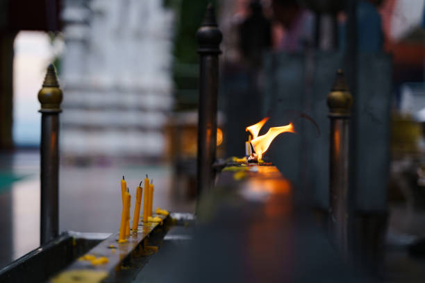Buddhist tradition for light a candle for praying at temple in Asian country of Thailand Thailand