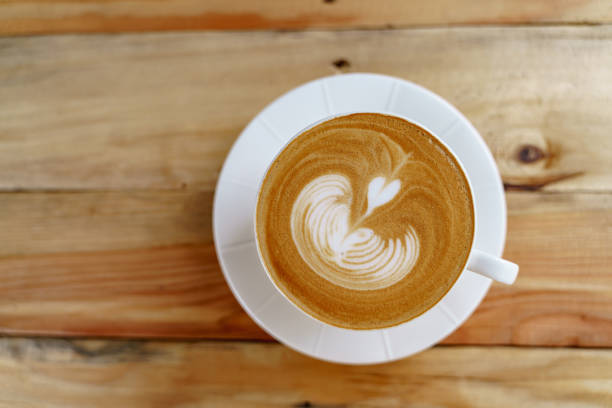 Cup of coffee with latte art pattern milk foam