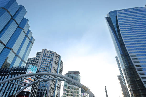 Skyline at Sathon square in Bangkok. View up from pedestrian bridge connected to main bridge Sathon to high buildings of modern financial and business district in Bangkok. In bottom area is one of arches of Sathon bridge.