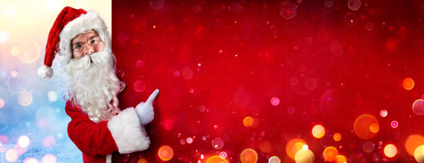 istock Santa Claus Pointing With Finger On Billboard 1190140388