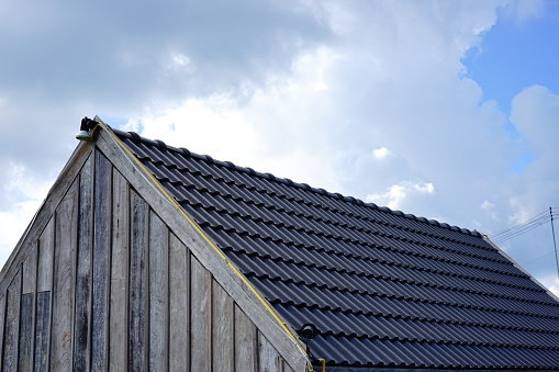 Roof tile house against blue sky