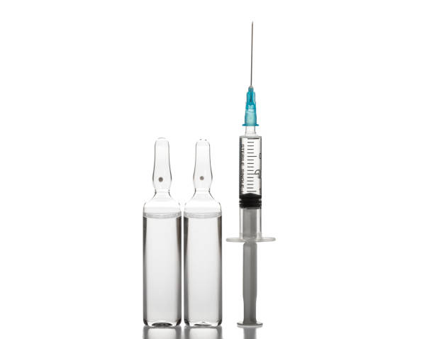 istock Glass medicine ampoules and Syringe on white background 1190141386