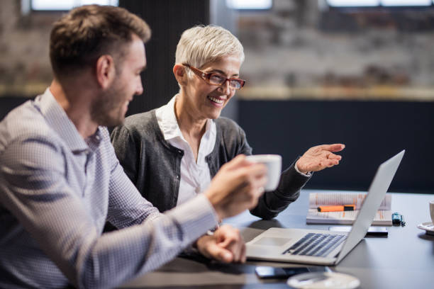 istock Happy business colleagues cooperating while reading an e-mail on laptop in the office. 1190141698
