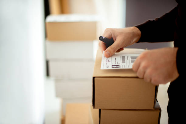 istock Delivery service, applying a shipping label 1190142315