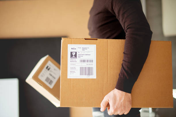 istock Young man carrying packages for shipment 1190142478