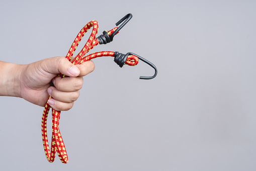 Hand Holding Elastic Rubber Rope With Hook On The End Stock Photo -  Download Image Now - iStock