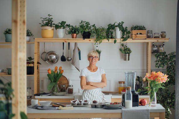 istock Senior Woman Standing at Kitchen 1190142924