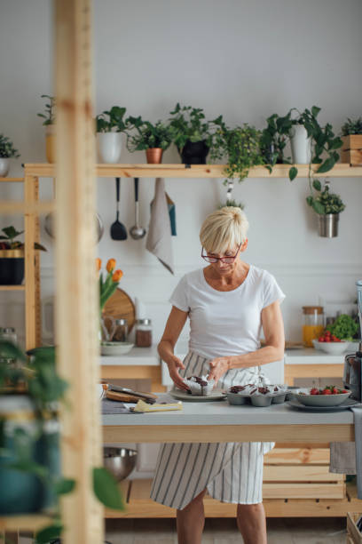 istock Woman Baking Muffins 1190143173