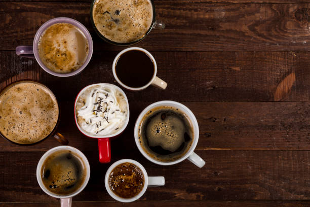 istock Lots of coffee in different cups on wooden table 1190146070