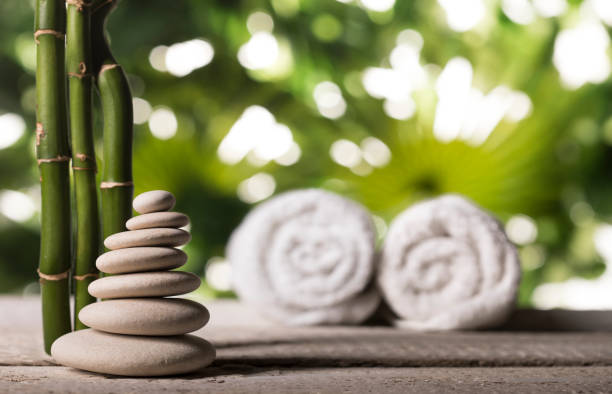 istock Grean bamboo leaves over zen stones pyramid on tropical leaves background 1190146946