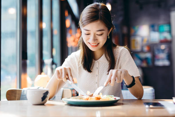 Young Asian woman  eating fresh salad at cafe. Brunch, Smart Phone, Women, Breakfast, Healthy Lifestyle, China - East Asia, Shanghai, Adults Only chinese ethnicity china restaurant eating stock pictures, royalty-free photos & images