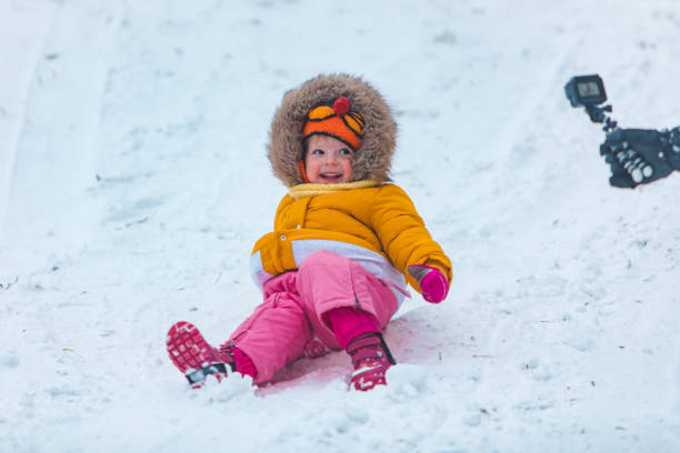 istock little kid at sledge sliding down by winter hill 1190147580