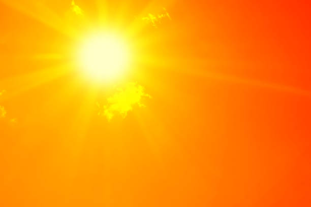 istock Bright sun with beautiful beams in the sky with clouds (toned in red) 1190147645