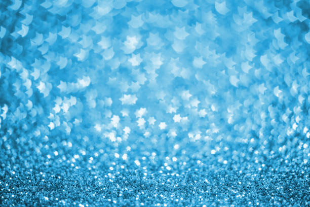 Blue Christmas background - defocused bokeh with a six-pointed star shape. Space for copy. It's a REAL bokeh photo, not an illustration or computer filter.
