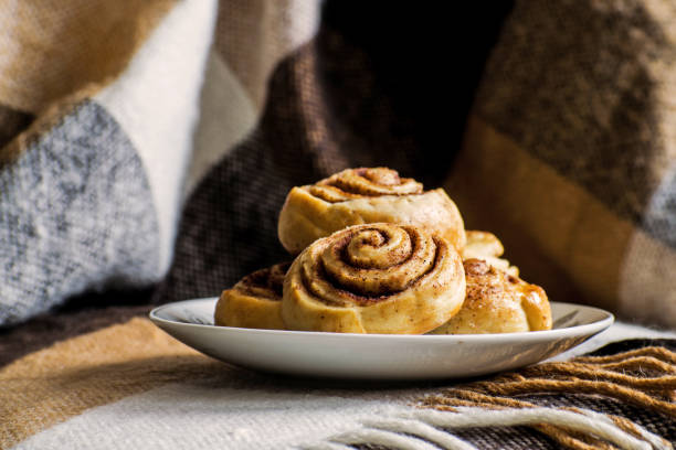 Cinnamon rolls buns with spices and cocoa. Kanelbulle - swedish sweet homemade dessert. Christmas baking pastry. Sweet cinnamon rolls buns with spices and cocoa. Christmas baking pastry. kanelbulle stock pictures, royalty-free photos & images