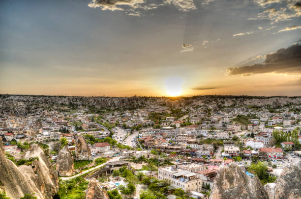 Sunset panoramic view to Goreme city, Cappadocia, Turkey sunrise panoramic view to Goreme city and pigeon valley Cappadocia, Turkey niğde city stock pictures, royalty-free photos & images
