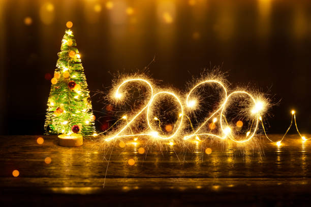 istock Christmas Composition with Christmas tree and Sparkler 2020 on old wooden table 1190150321