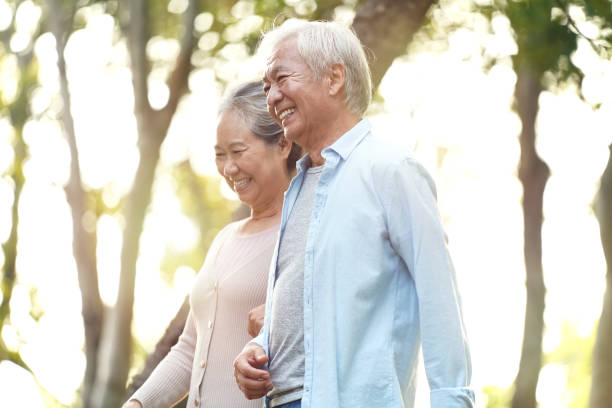 istock senior asian couple walking outdoors in park 1190151753