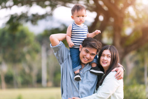 istock Happy Family Against Trees In Park 1190152337