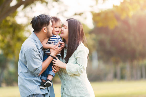 istock Family Against Trees In Park 1190152348