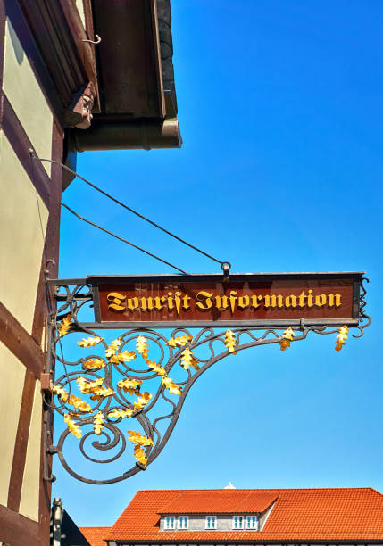 istock Tourist information as text in ancient scripture on a old sign. 1190153212