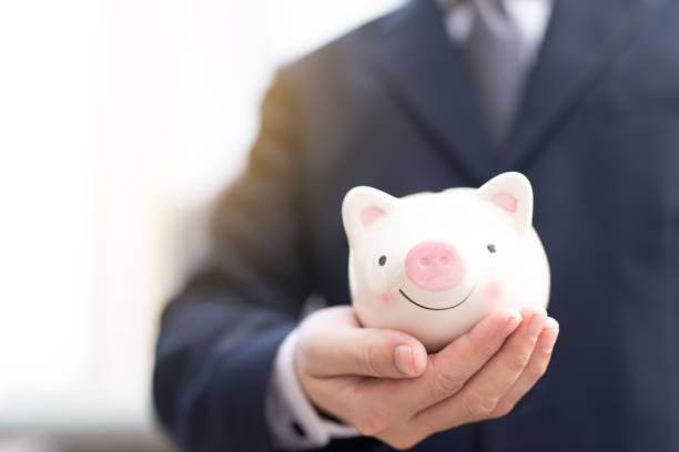 istock A man holding a piggy bank 1190154988