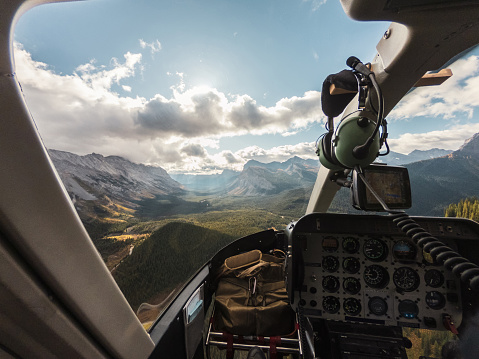 Inside of Helicopter on canadian rockies with sunlight in assiniboine provincial park