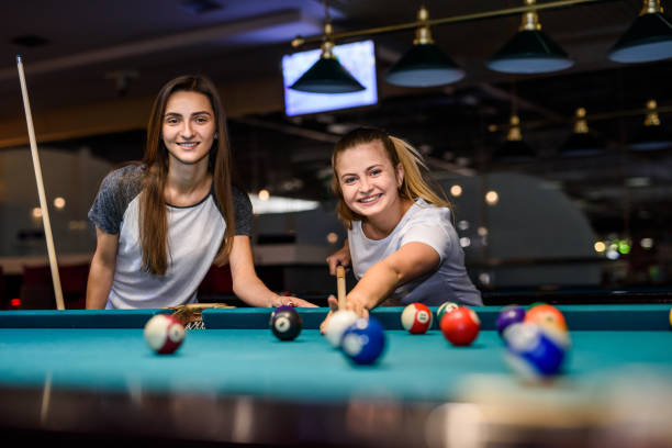 istock Two friends playing billiard in pub. Gambling concept 1190158906