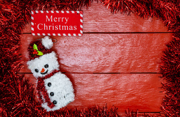 istock Christmas composition on red wooden board with Christmas garland and decorations. Creative composition with border and copy space, top view, flat lay. Christmas frame. 1190159532
