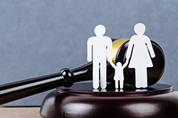 istock Family figure and gavel on table. 1190159562