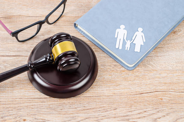 istock Family figure and gavel on table. 1190159615