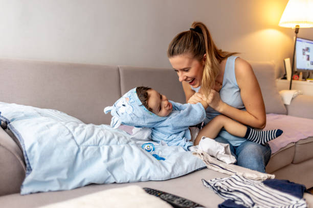istock Smiling mother is making child laugh indoors 1190159761