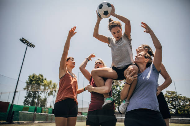 Women soccer team celebrating victory Group of women, female soccer players together outdoors, celebrating victory. football player girlfriend stock pictures, royalty-free photos & images