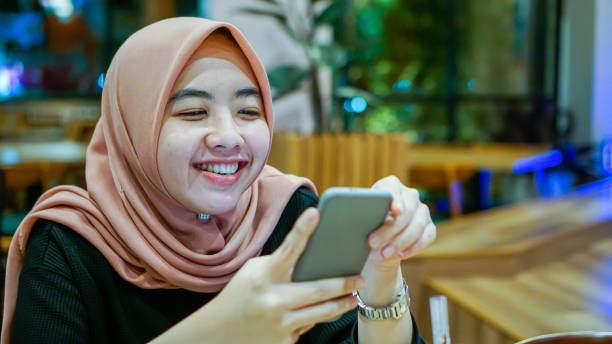 istock Millennial Asian Women Smiling While Texting 1190163141