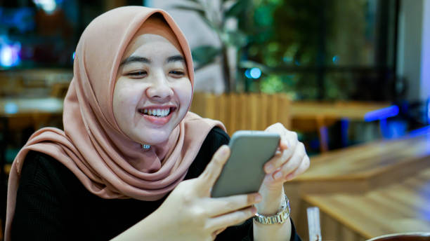 istock Millennial Asian Women Smiling While Texting 1190163149