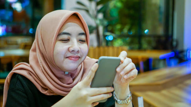 istock Millennial Asian Women Smiling While Texting 1190163200