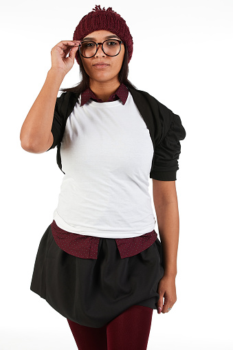 Brown hair female model with a cute geeky, preppy style displaying a blank t-shirt to design your mock-up.