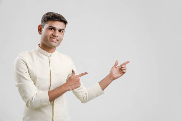 istock young indian man in Ethnic wear and showing direction with hand 1190164143