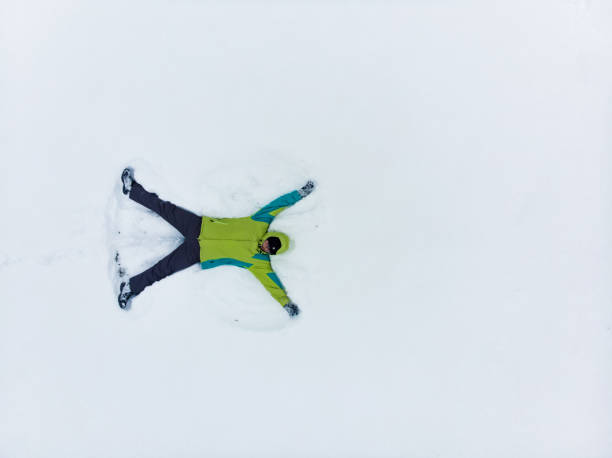 istock overhead view of man making snow angel 1190167057