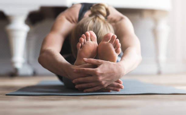istock Young balerine stretching on sport mat before exercising 1190168575