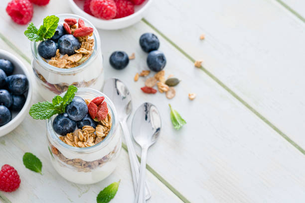 istock Healthy food: homemade yogurt with granola on breakfast table. Copy space 1190168798