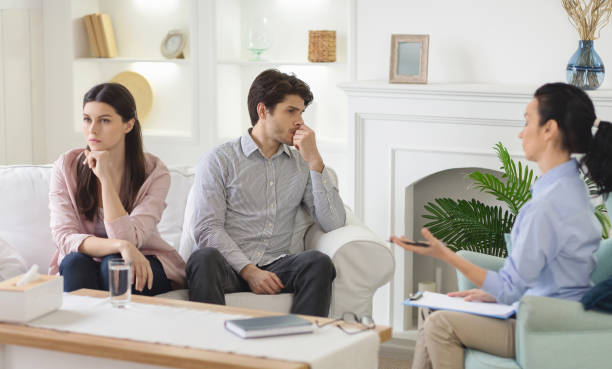 istock Married couple after quarrel ignoring each other at therapist office 1190169149