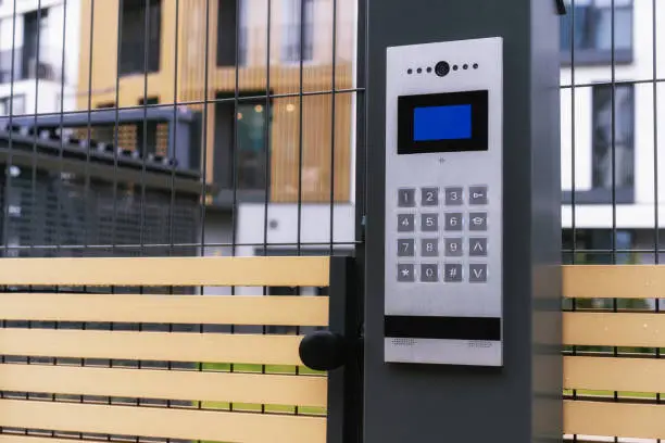 Photo of safety in modern residential buildings. fenced yard, closed gate with electronic lock.