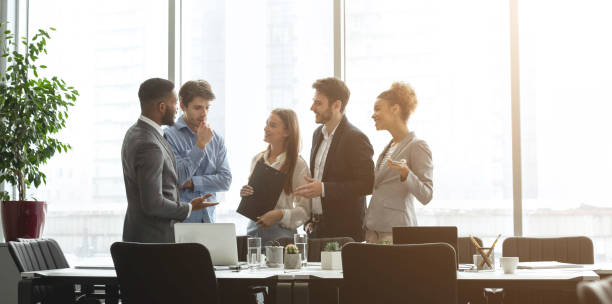 istock Successful business team talking against office windows 1190170696