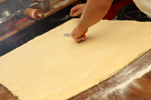 Confectioner prepares puff pastry and empty space for text