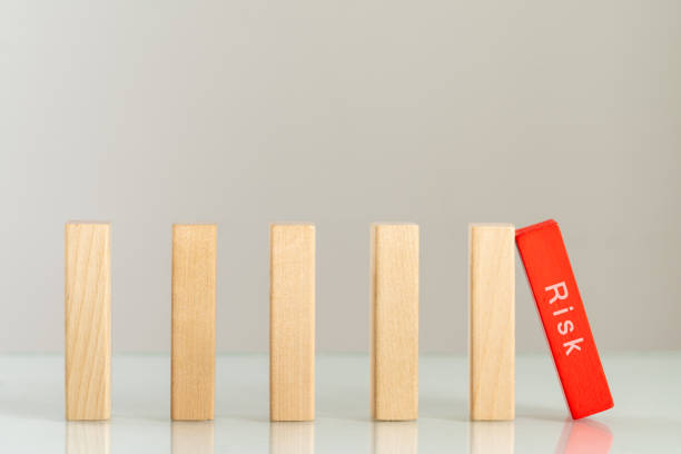istock Wood blocks domino for risk management concept. 1190171726